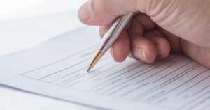 photo: person filling out a paper application form